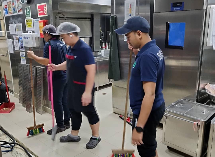 Housekeeping team cleaning a commercial kitchen facility